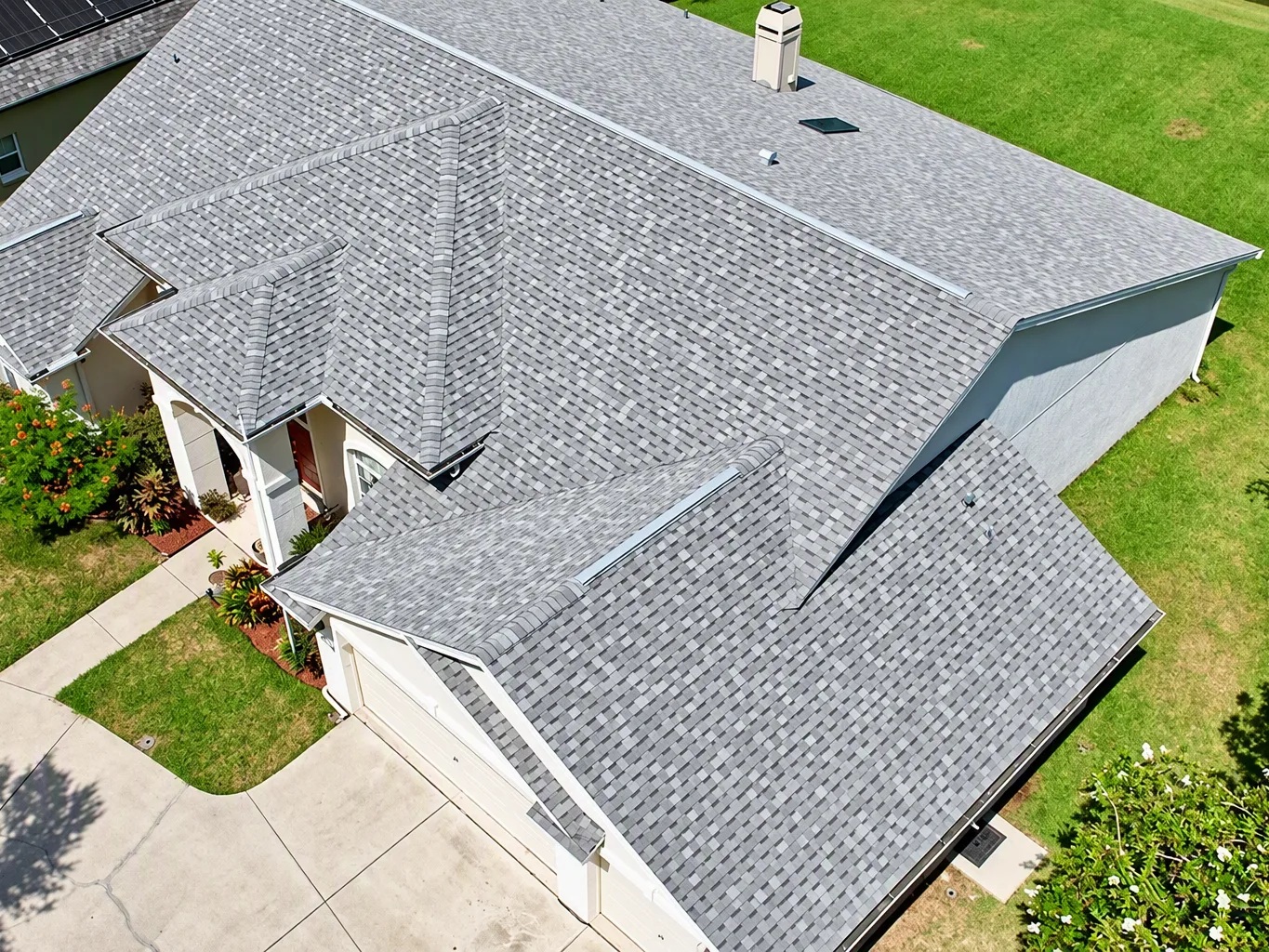 A roofer working on a residential roof maintenance plans job — mid-task, hands, tools and the work itself in sharp focus, the rest of the space softly out of focus