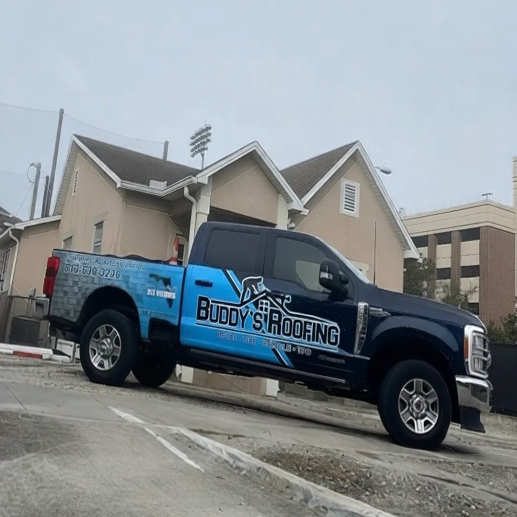 A set of tools — a nail gun and chalk line — laid down on a clean surface beside the roofing work they have just finished, everything tidy and put away